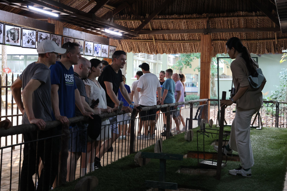 外国游客聆听导游讲解竹签陷阱在战斗中的作用。图自 越通社