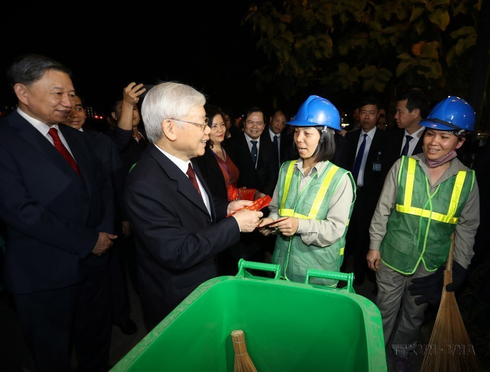 阮富仲总书记、国家主席2019年2月4日在首都河内西湖区看往慰问除夕值班的环卫工人，并赠送礼物。图自越通社