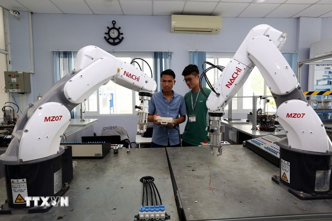 学员们在胡志明市高科技园区培训中心进行机器人编程与操作实训。图自越通社 robot.jpg