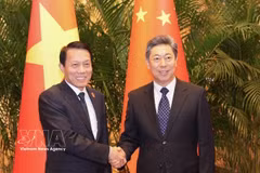 越共中央政治局委员、公安部长梁三光大将（左）与中共中央政治局委员、中央政法委员会书记陈文清。图自越通社