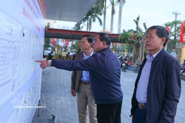 海进乡第三投票区的选民正在了解国会代表及各级人民议会代表候选人的相关信息。图自越通社