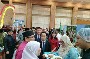 越南驻文莱大使陈英宇向文莱外交与贸易部第二部长艾瑞万介绍越南美食。图自越通社