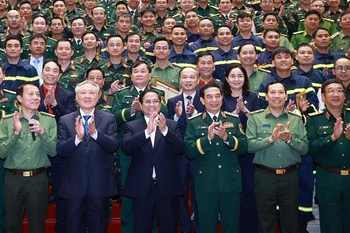 范明政同与会代表合影。图自越通社