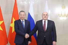 越共中央总书记苏林与见俄罗斯联邦总理米舒斯京亲切握手。图自越通社
