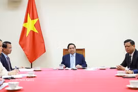 越南政府总理范明政与卡塔尔首相兼外交大臣通电话 。图片来源：越通社