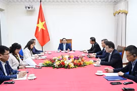 越南政府总理范明政与阿拉伯联合酋长国总统通电话。图片来源：越通社