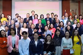 范明政总理和夫人与旅法侨胞和大使馆工作人员合影。图自越通社