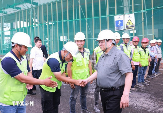 越南政府总理范明政视察位于河内市东英县的国家会展中心建设工地。图自越通社