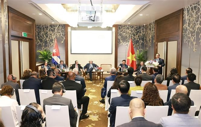 范明政在会上发表讲话。图自越通社