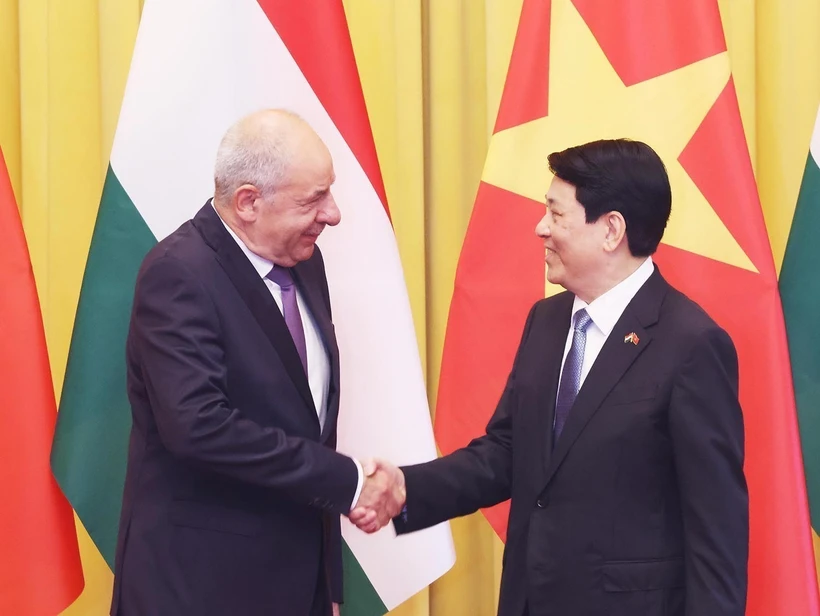 越南国家主席梁强与匈牙利总统舒尤克·道马什亲切握手。图自越通社