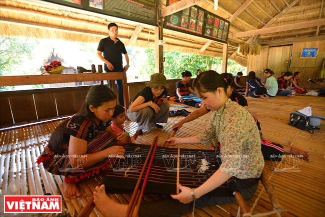 游客在若拉村参观织锦。本报记者 清和 摄