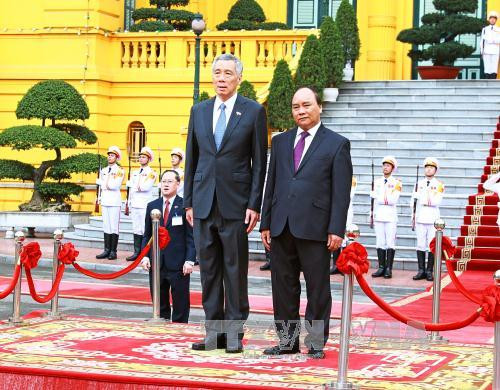 新加坡总理李显龙与夫人的欢迎仪式3月23日上午在主席府隆重举行。（图片来源：越通社）