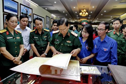 第 7 军区司令部领导、战士和胡志明市青年一同参观展览会。（图片来源：越通社）