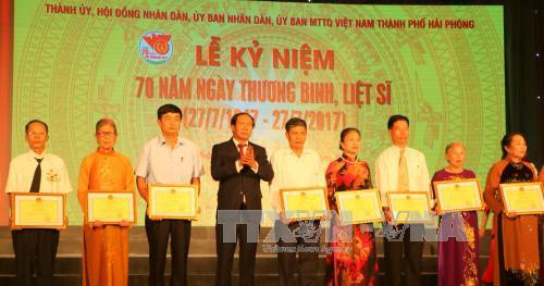 海防市市委书记黎文成向革命有功人员家属颁发奖状。（图片来源：越通社）