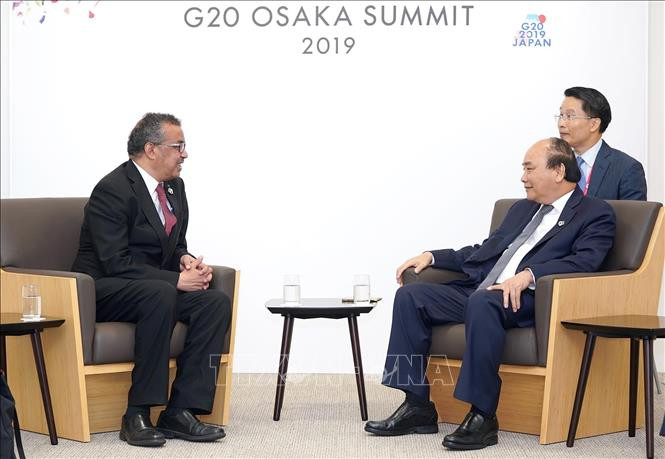 阮春福会见世界卫生组织总干事特沃德罗斯·阿达诺姆。越通社记者 统一 摄