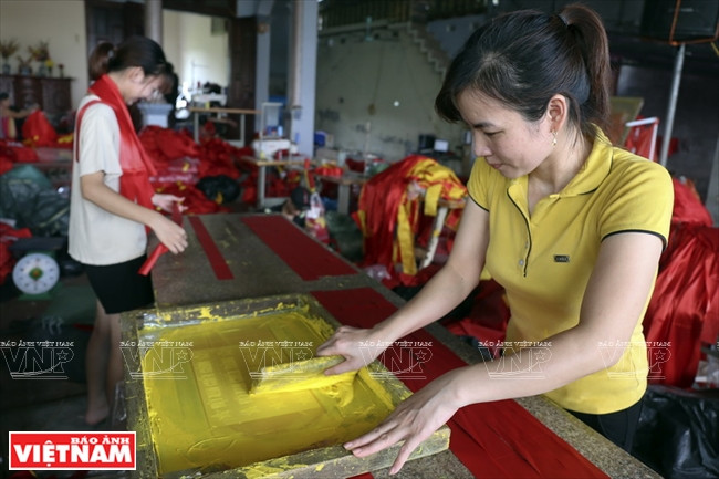 在足球赛期间，除了国旗外，慈云村民还大批生产横幅和彩带，满足球迷的需求。图自越通社/越南画报