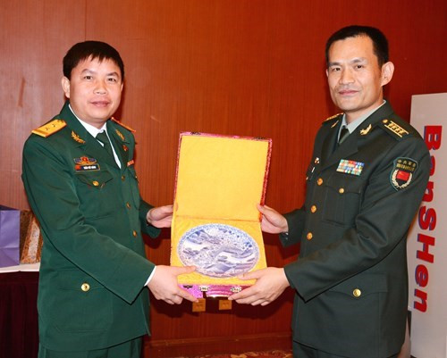 刘忠斌大校向陈曰能中校赠送纪念品。