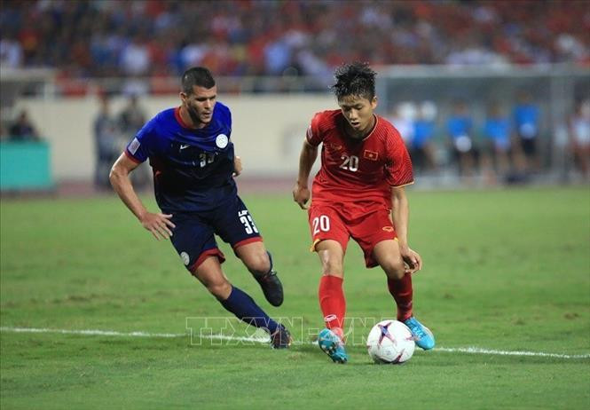 越南球员潘文德（红衣）。图自越通社