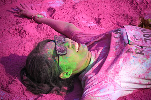 参加者身着白色T恤，跑步过程中经过不同的彩色站，会被从头到脚抛撒彩色粉末。