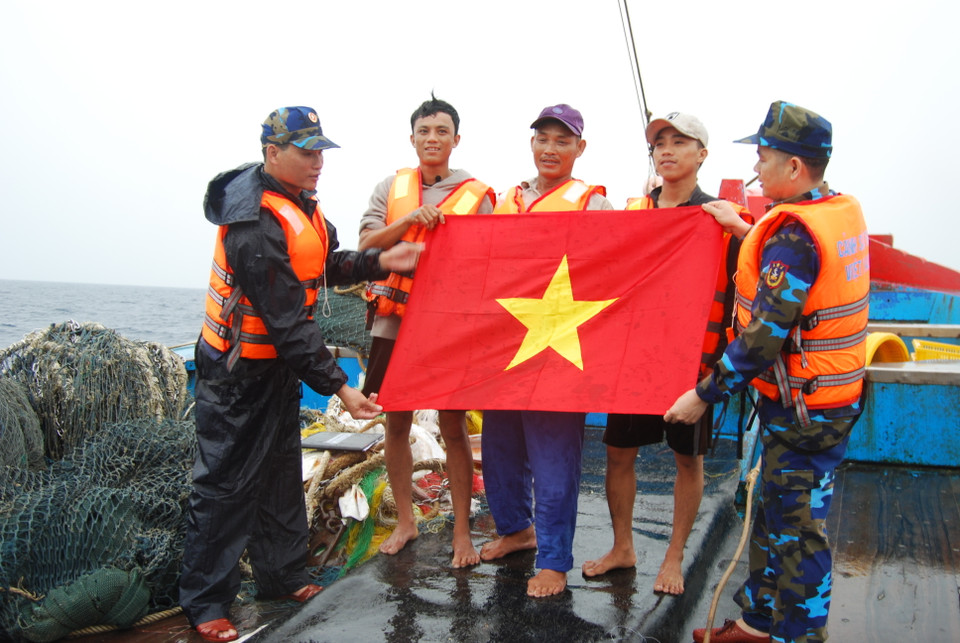 越南海警向越南渔民赠送越南国旗。（图片来源：越通社）