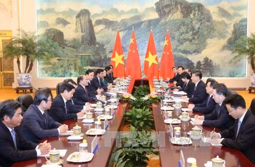  12 月 23 日下午在人民大会堂，越南国会主席阮生雄会见了中共中央总书记、中国国家主席习近平。（图片来源：越通社）