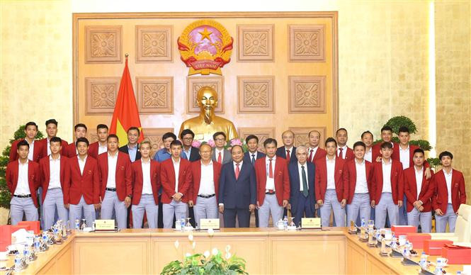 阮春福总理与越南男足队和教练员合影。 越通社记者统一 摄