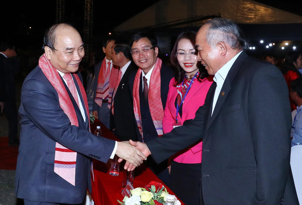 政府总理阮春福和出席活动的代表们握手。图自越通社