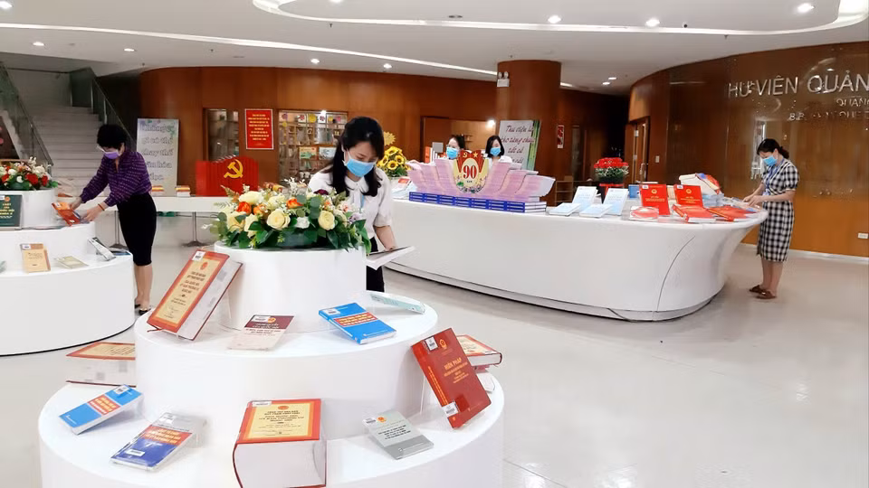 广宁省图书馆干部人员在展示厅摆放书籍。图自越通社
