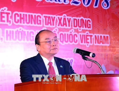 阮春福在2018戊戌年迎新春见面会上发表讲话。越通社记者 统一 摄