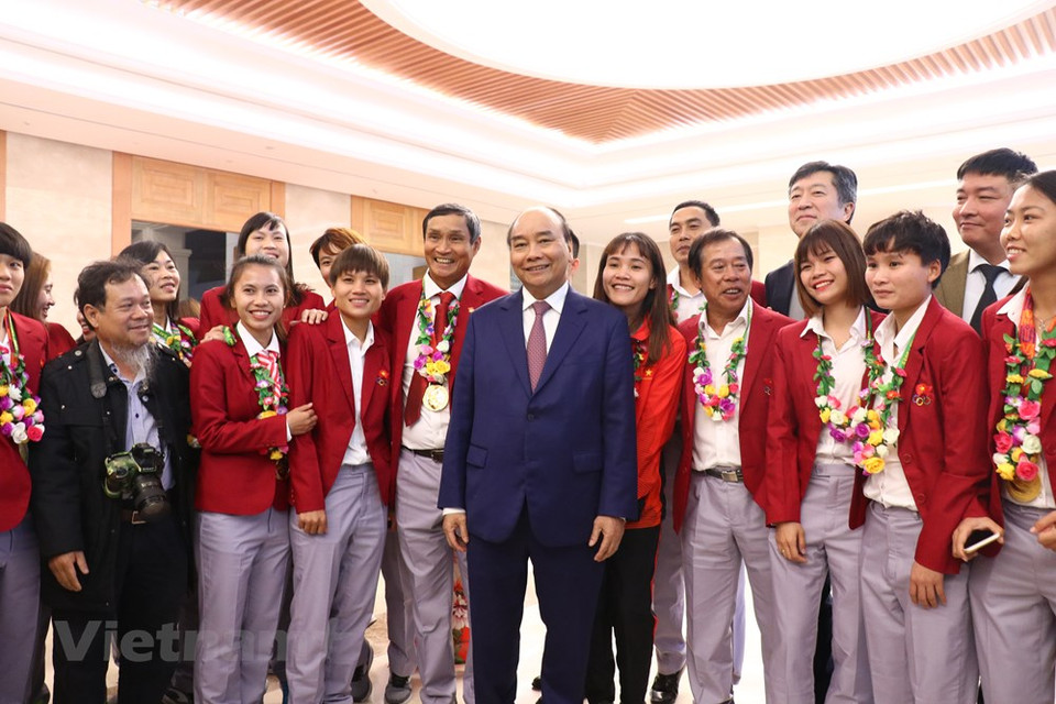 阮春福总理在庆功宴前与越南女足球队合影。越通社记者 原安 摄