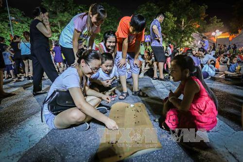  河内市儿童在步行街玩传统游戏。（图片来源：越通社）