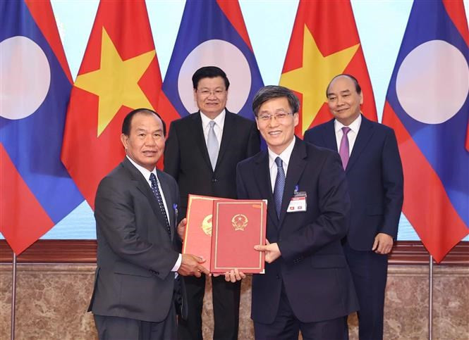 阮春福总理与老挝总理通伦•西苏里共同见证2021年越老合作计划协议以及越老政府间联合委员会第43次会议纪要签字仪式。图自 越通社