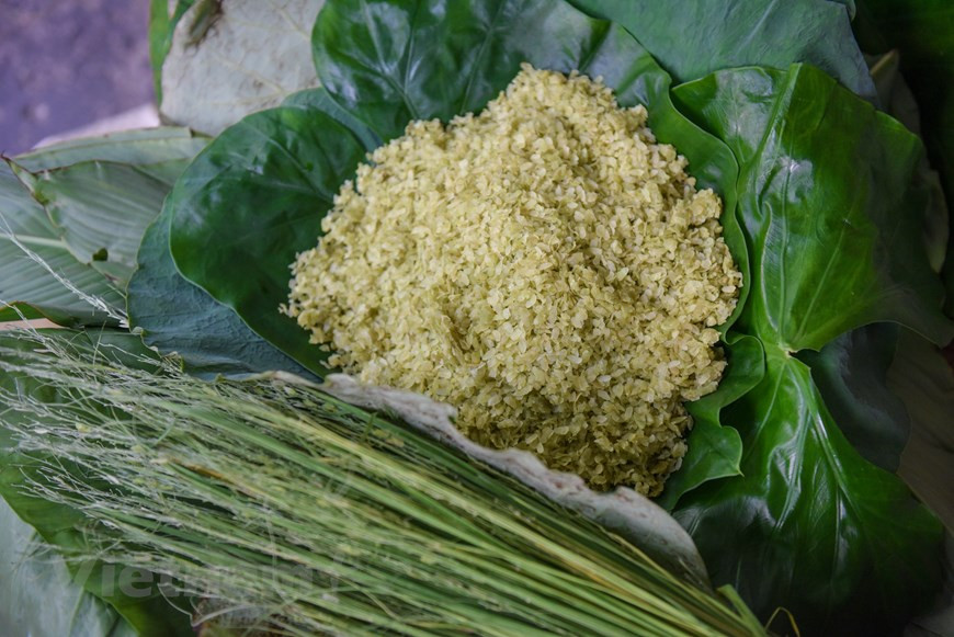 糯米刚熟便拿出去放凉，凉后去舂。舂这一步也很重要，要反复舂扁糯米才好吃。接着，手巧的人将筛把剩下的稻壳、颖选净。扁糯米做完之后马上被仔细地包裹起来，用绿色的稻草绑住，以保持湿润柔软，也让其吸收荷叶的香味。荷叶象征着纯洁清雅，其与扁糯米的混搭创造了该产品独特的香甜。图自Vietnam+