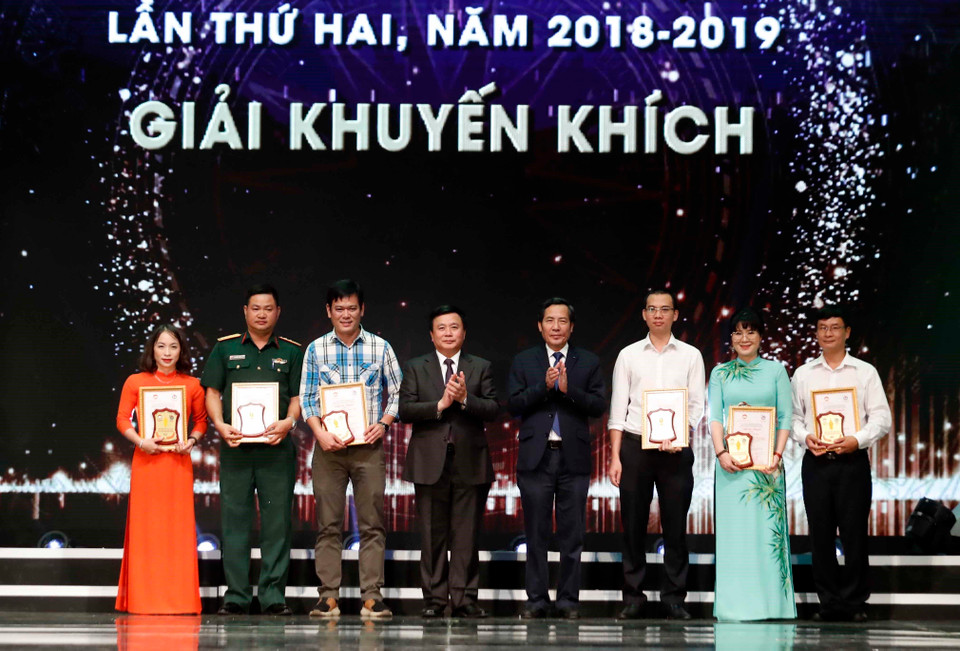 胡志明国家政治学院院长阮春胜和越南新闻工作者协会主席顺友向获得优秀奖的作者颁发奖状。越通社记者 统一 摄