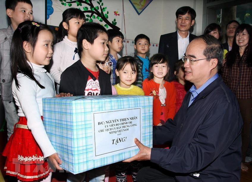 越南祖国阵线中央委员会主席阮善仁2015年3月27日向河内市丹凤县新会幼儿园的儿童们送上礼物。越通社发