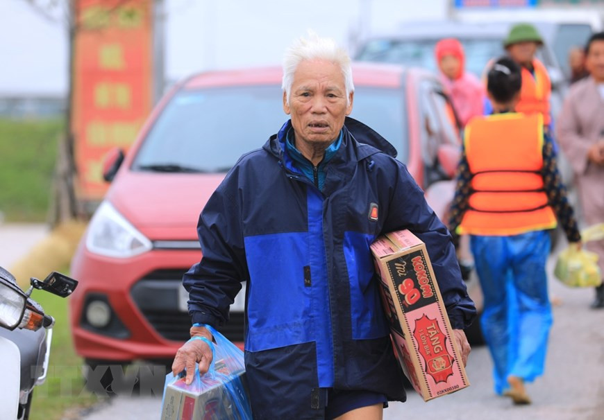 各地方灾民领到生活必需的食品和其他救援物资。图自越通社