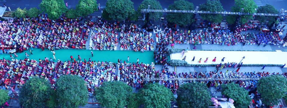 3月3日上午，3000多人在阮慧步行街一起穿着奥黛走秀。图自越通社