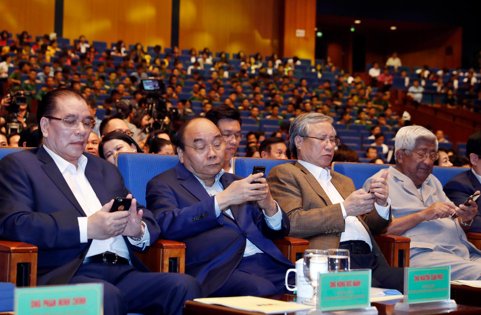 阮春福同与会代表发短信支持活动。图自越通社