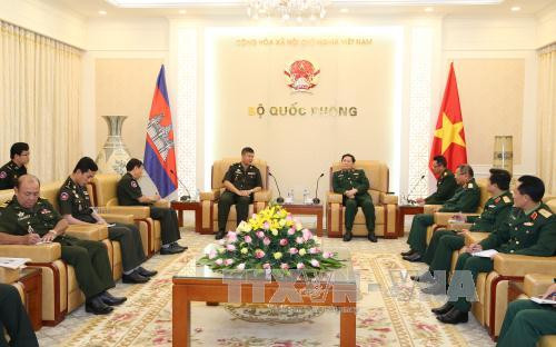 越共中央政治局委员、越南国防部部长吴春历大将（右）3月27日下午在河内会见了前来礼节性拜会的柬埔寨皇家军队情报研究总局总局长洪玛尼（音译）中将。（图片来源：越通社）