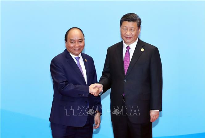 越南政府总理阮春福与中共中央总书记、国家主席习近平合影。图自越通社