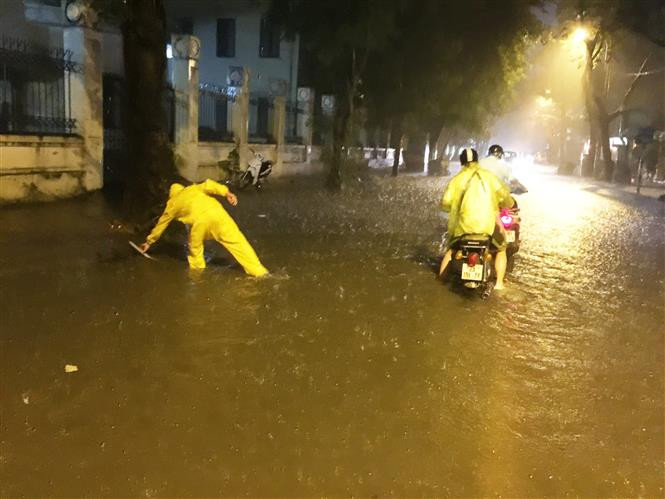 首都河内遭遇强降雨，多条街道被淹。排水工程人员参加排水。越通社记者 林庆 摄