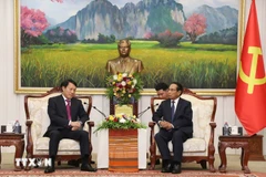 老挝人民革命党中央政治局委员、书记处常务书记、老挝国家副主席本通·吉玛尼会见越共中央政治局委员、公安部部长梁三光大将。图自越通社