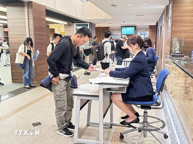 考生在考场办理手续。图自越通社