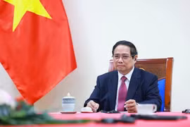 越南政府总理范明政与新西兰总理克里斯托弗·拉克森通电话。图自越通社