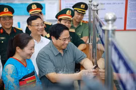 范明政总理视察清化省山区边境乡钵默行政审批工作。图自越通社
