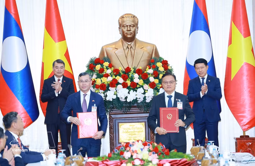 越南政府总理黎明兴与老挝政府总理沙伦赛·贡马西见证两国政府财政领域合作协定的交换仪式。图：越通社